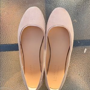 Suede tan flats with rose gold trim.